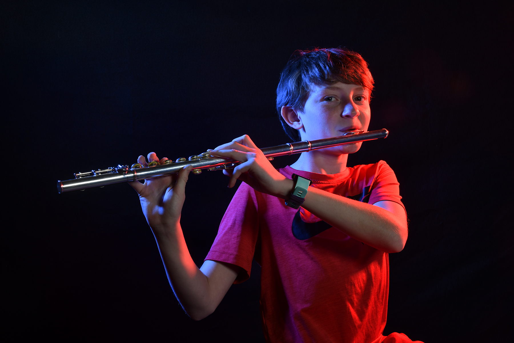 A middle school boy plays his flute