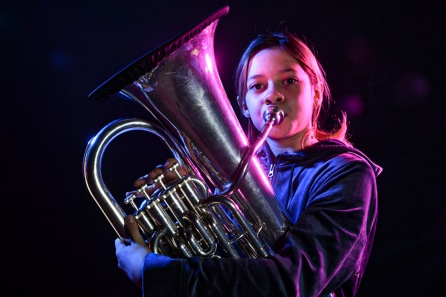 A middle school girl plays her tuba